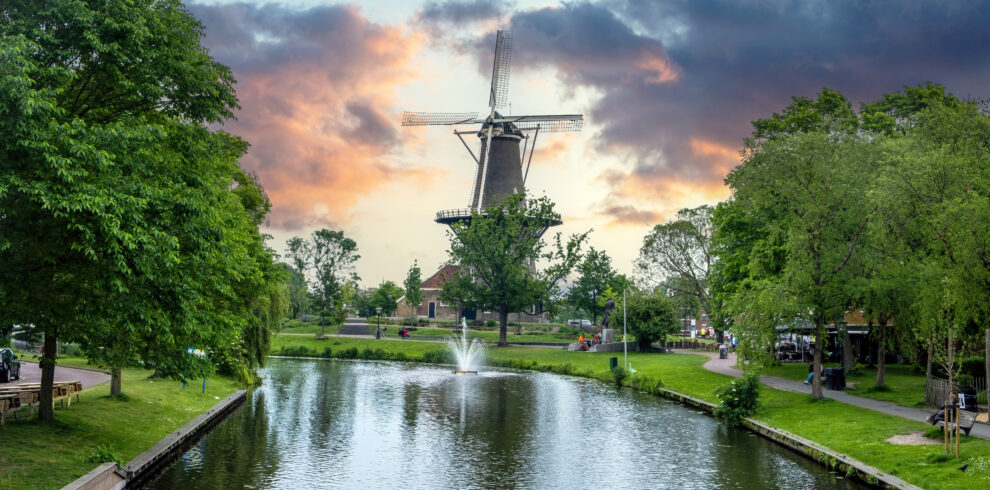 Windmill De Valk at sunset, tower mill and museum in Leiden city, Holland Netherlands.